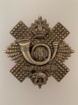Highland Light Infantry cap or bonnet badge ANTIQUED.